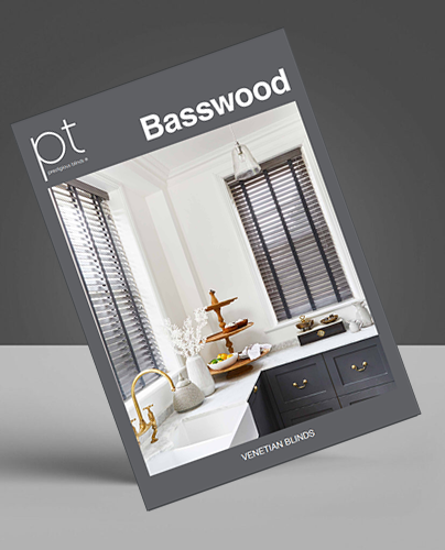 A magazine cover featuring a modern kitchen with white walls, gold handles, and made-to-measure Venetian blinds over the windows.