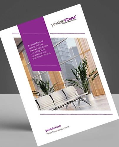 A brochure tilted at an angle features the Yewdale Vitesse logo, a photo of a modern waiting area with white seating and large windows, and a purple banner with text about commercial curtain track and commercial blinds solutions.