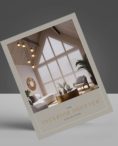 A brochure titled The Interior Shutter Collection featuring a modern living room with tall windows, white shutters, stylish furniture, a round mirror, and a potted plant against a neutral background.