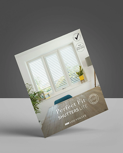 A brochure featuring white window shutters in a bright room with a wooden desk, green chair, and plant. Text reads Perfect Fit Shutters Lite and includes certification badges.