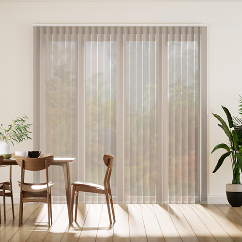 Modern dining area with wooden table and chairs near large windows covered by made-to-measure vertical blinds. Two potted plants sit by the table and window, as sunlight fills the bright, minimalist room.