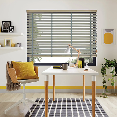 A modern home office with a desk, chair, houseplants, and made to measure Venetian blinds letting in natural light.